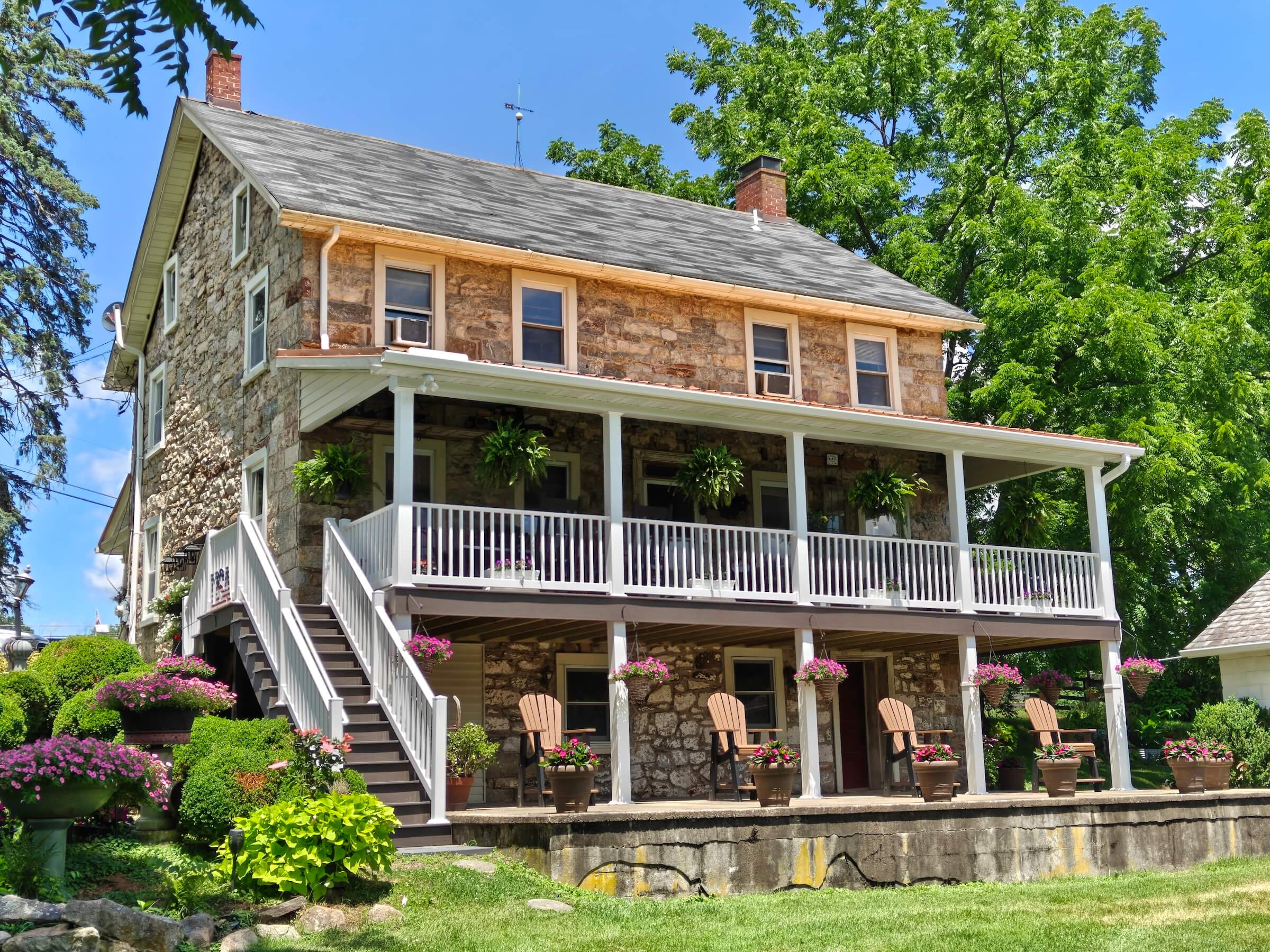 angled view of a farmhouse with new roof and patio roof